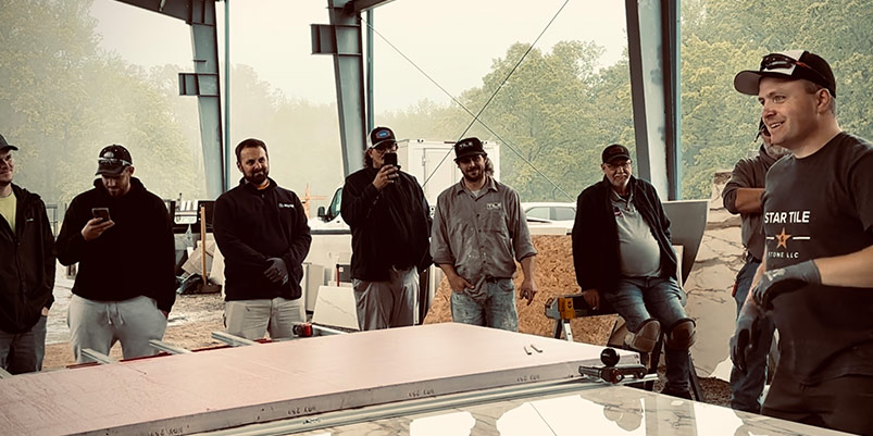 Pavlo "Pasha" Starykov instructs students at a tile panel installation training.